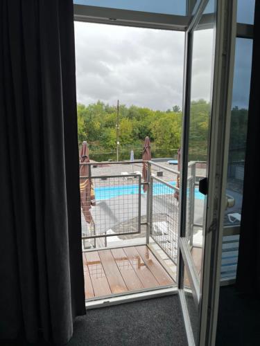 a balcony with a view of a swimming pool at Дача in Kryvyi Rih