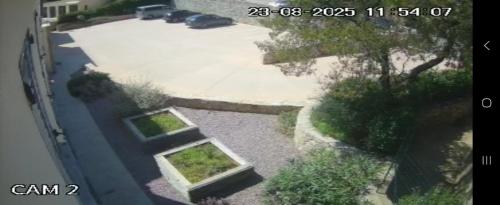an aerial view of a driveway with a car parked at Résidence U Manellu in Santa-Reparata-di-Balagna