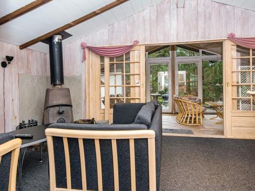a living room with a couch and a stove at 5 person holiday home in Herning-By Traum in Kølkær