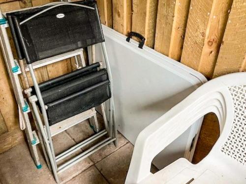 a chair sitting in a corner next to a wall at 5 person holiday home in Herning-By Traum in Kølkær