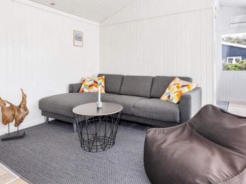a living room with a couch and a table at 6 person holiday home in Løkken-By Traum in Nørre Lyngby