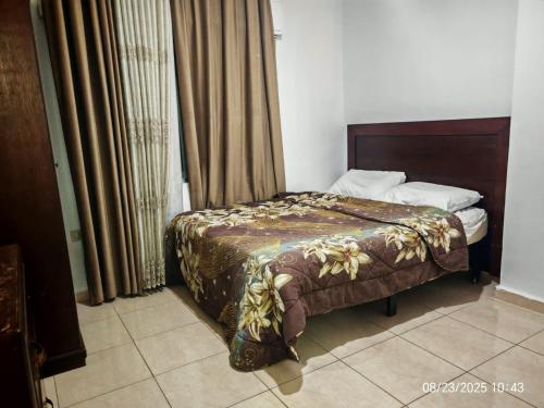 a bedroom with a bed and a window with curtains at EVANNA SUITE AND HOTELs ايفانا للشقق الفندقيه و المفروشه in Amman