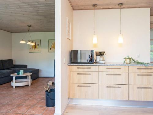 a kitchen and living room with a couch at 4 person holiday home in Børkop-By Traum in Børkop