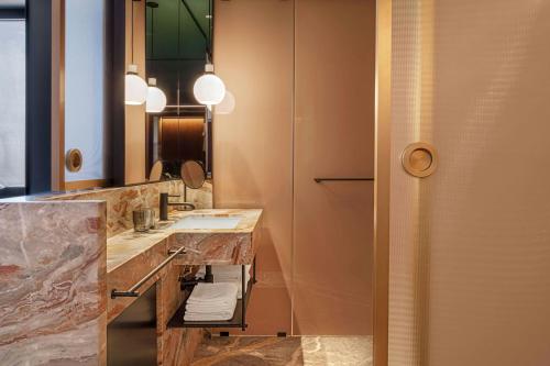 a bathroom with a sink and a mirror at Casa Brera, a Luxury Collection Hotel, Milan in Milan