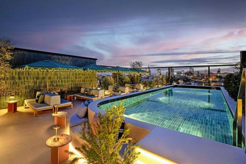 a swimming pool on top of a building at Casa Brera, a Luxury Collection Hotel, Milan in Milan
