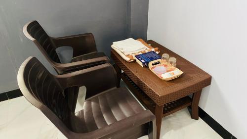 a table with a chair with a tray of food on it at Sagar Hotel 