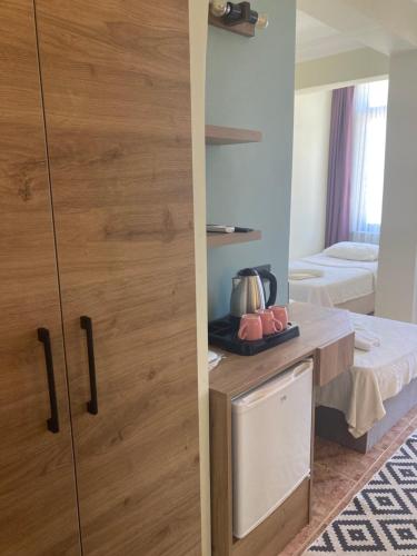 a room with a wooden door and a bed at Olimpia Hotel in Fethiye