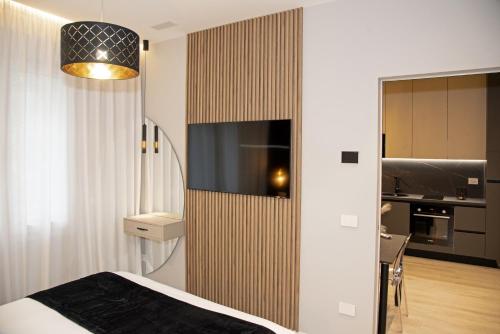 a bedroom with a bed and a tv on a wall at The Three Diamonds - B&B CESENATICO in Cesenatico