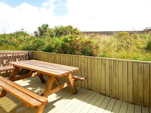 a wooden picnic table and bench on a wooden deck at 6 person holiday home in Lemvig-By Traum in Trans