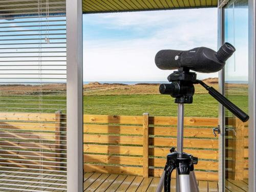 a camera in front of a window with a view of the ocean at 6 person holiday home in Lemvig-By Traum in Trans
