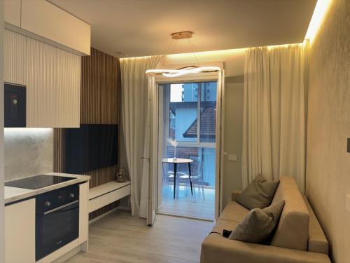 a living room with a couch and a kitchen at The Three Diamonds - B&B CESENATICO in Cesenatico