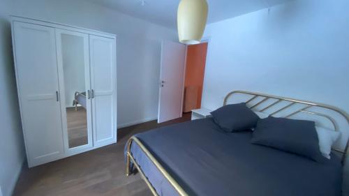 a bedroom with a bed with blue pillows on it at Casa Lu' in Rocca Pia