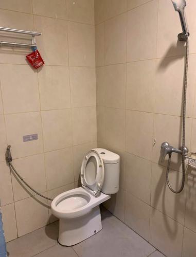 a bathroom with a shower and a toilet with the seat up at PH Residence Jakarta - Gajahmada in Jakarta