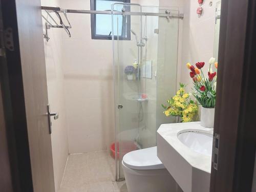 a bathroom with a shower and a toilet and a sink at Trăng Khuyết 404MD in Hanoi