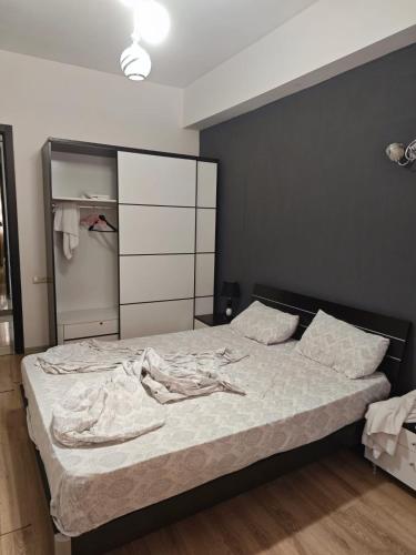 a bedroom with a bed with a black wall at Modern Suite in Tbilisi City