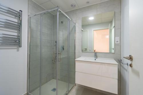 a bathroom with a glass shower and a sink at Modern 2BR Apt with own Terrace & Pool access in Pulpí