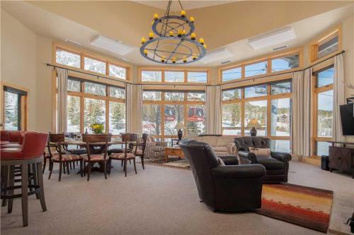 a living room with a table and chairs and a chandelier at RMR: Cody House B Condo in Teton Village in Teton Village