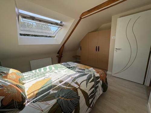 a bedroom with a bed with a colorful comforter at Ty bihàn de kergouet in Crédin