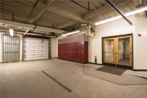 an empty garage with two doors and two garage stalls at RMR: Cody House D Condo in Teton Village in Teton Village