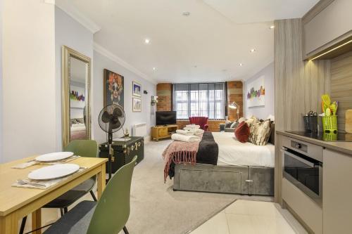 a bedroom with a bed and a living room at 58 Cocoa Suites Riverside Studio with Parking in York