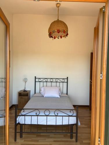 a bedroom with a bed and a chandelier at Villa Silvana Quiet Escape in Bolsena