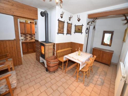 a dining room with a table and a stove at Chalet in Malá Skála near Ski Slopes in Malá Skála