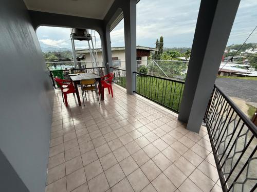 a porch with a table and chairs on a balcony at Lautoka Tropical Haven 4BR with Amazing Views in Lautoka