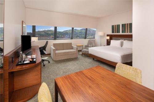 a hotel room with a bed and a desk with a desk at Hilton Garden Inn Mbabane in Mbabane