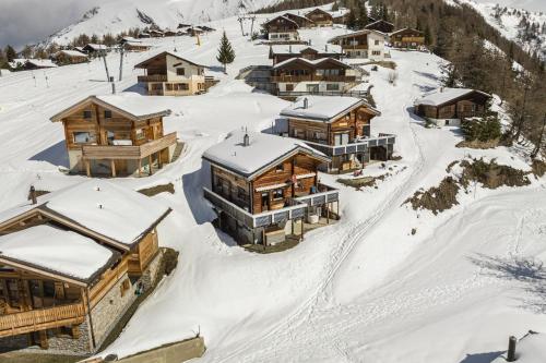 an aerial view of a resort in the snow at Chalet mit Sauna an der Piste in Rosswald