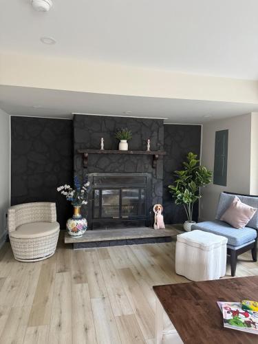 a living room with a fireplace and a blue chair at Bala At the Beach - Somers Point, NJ in Somers Point