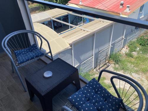 a chair and a table on a balcony at Olimpia Hotel in Fethiye