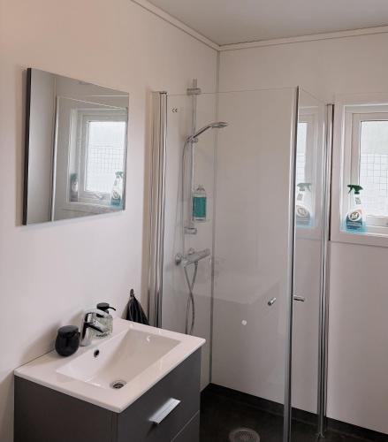 a white bathroom with a sink and a shower at House in Nordfjord, with 4 bedrooms in Nordfjordeid