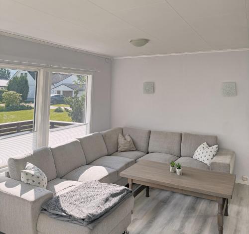a living room with a couch and a coffee table at House in Nordfjord, with 4 bedrooms in Nordfjordeid