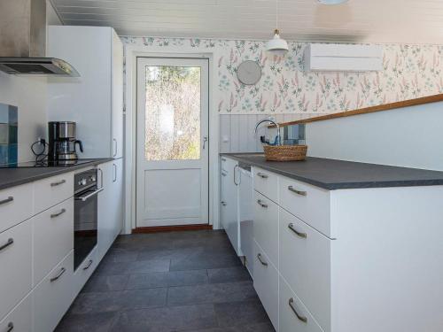 a kitchen with white cabinets and a counter top at 5 star holiday home in Silkeborg in Silkeborg