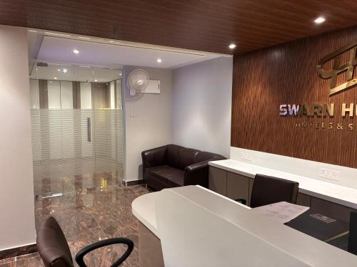 a conference room with a couch and a table and chairs at Swarn Hotel in Kolkata