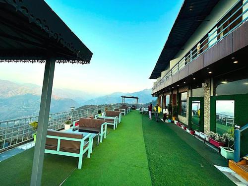 a balcony of a building with a view of the mountains at The Edge Retreat A Premium Property in Mussoorie