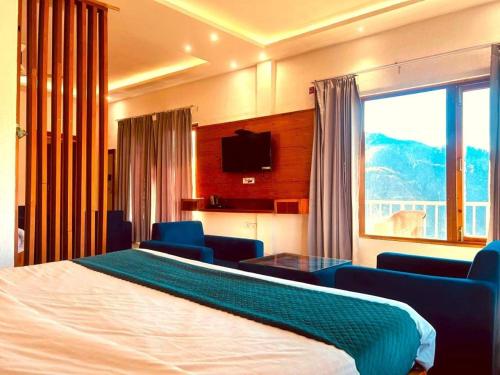 a hotel room with a bed and a large window at The Edge Retreat A Premium Property in Mussoorie