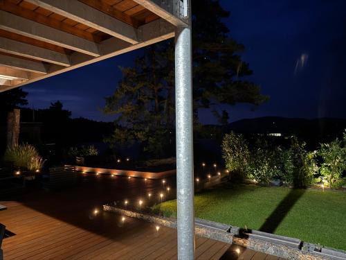 a patio with lights on the grass at night at Hrdlička Slapy Chalot in Buš