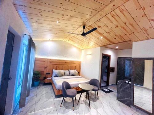 a bedroom with a bed and a table and chairs at The Edge Retreat A Premium Property in Mussoorie
