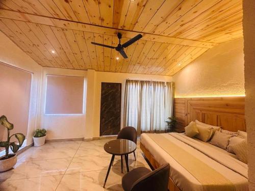 a bedroom with a bed and a ceiling fan at The Edge Retreat A Premium Property in Mussoorie