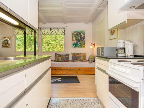 a kitchen with a counter and a couch in the background at 5 person holiday home in Ry in Ry