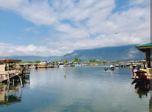 a body of water with houses and boats on it at Dilnaaz group of houseboats in Srinagar