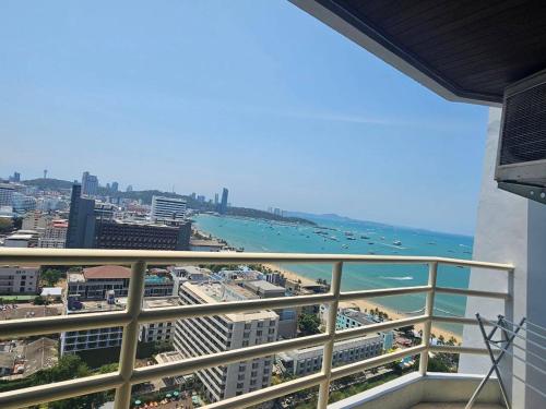 a balcony with a view of a beach and the ocean at View Talay6 by Blue Ocean Suite in Pattaya Central
