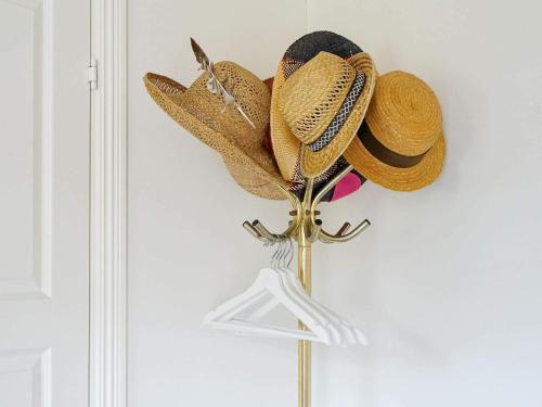 a bunch of hats hanging on a wall at 6 person holiday home in Laholm in Laholm