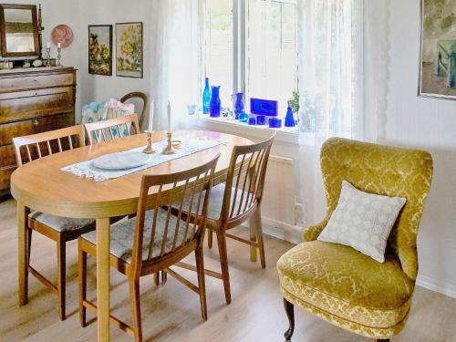 a dining room with a table and a chair at 6 person holiday home in Laholm in Laholm