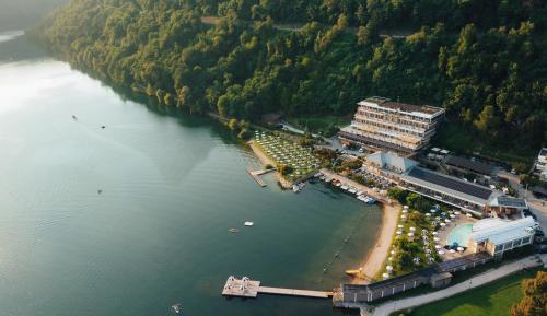 an aerial view of a building next to a river at Parc Hotel Du Lac in Levico Terme