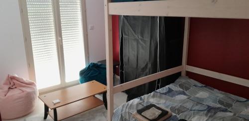 a bedroom with a bunk bed and a desk at Villa prestige in La Douze