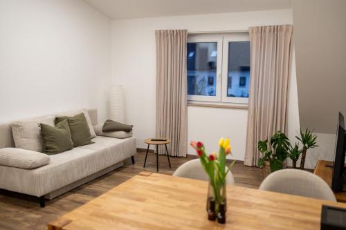 a living room with a couch and a table at Ferienwohnung Fränkische Auszeit in Wolframs-Eschenbach
