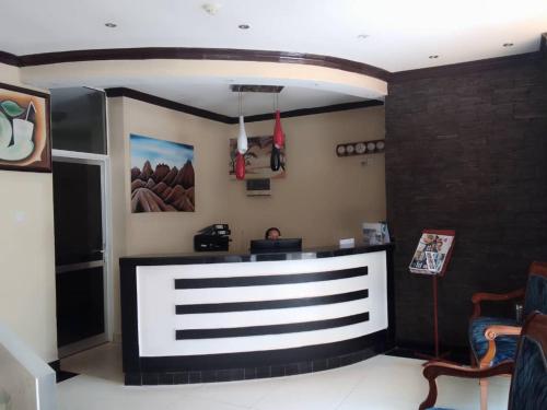 a restaurant with a counter in a room at Salama Hotel Kiyovu in Kigali