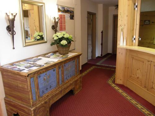 a room with a dresser with a mirror and flowers on it at Sportalm in Sölden